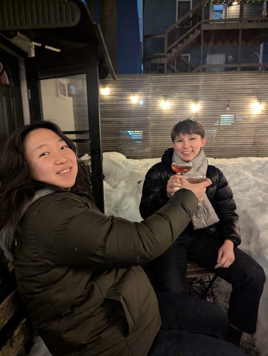 Amelie and Soeun raising a toast in Glou's snowed-in backyard