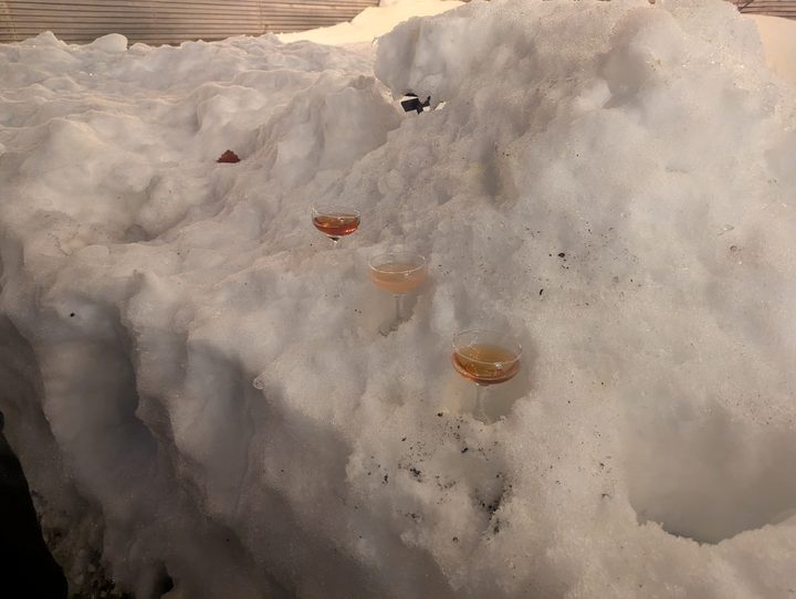 Three coupe glasses set into alcoves carved in the snow